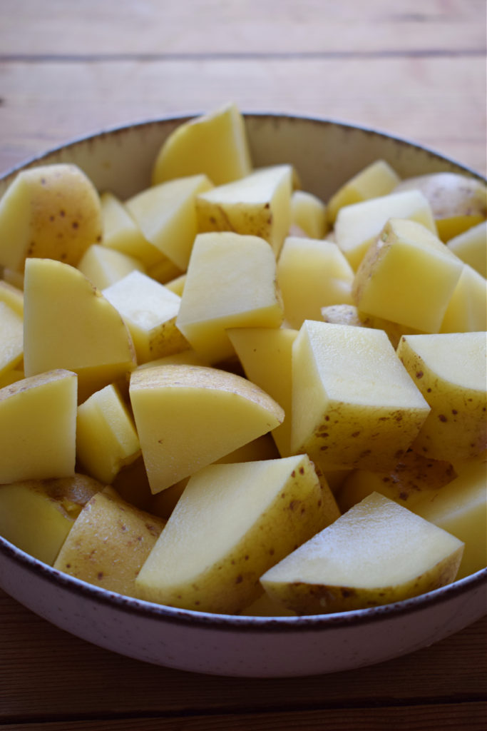 Cut and washed potatoes in a bowl.