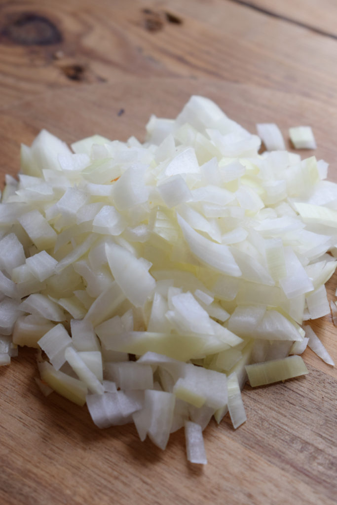 Diced onions on a cutting board.