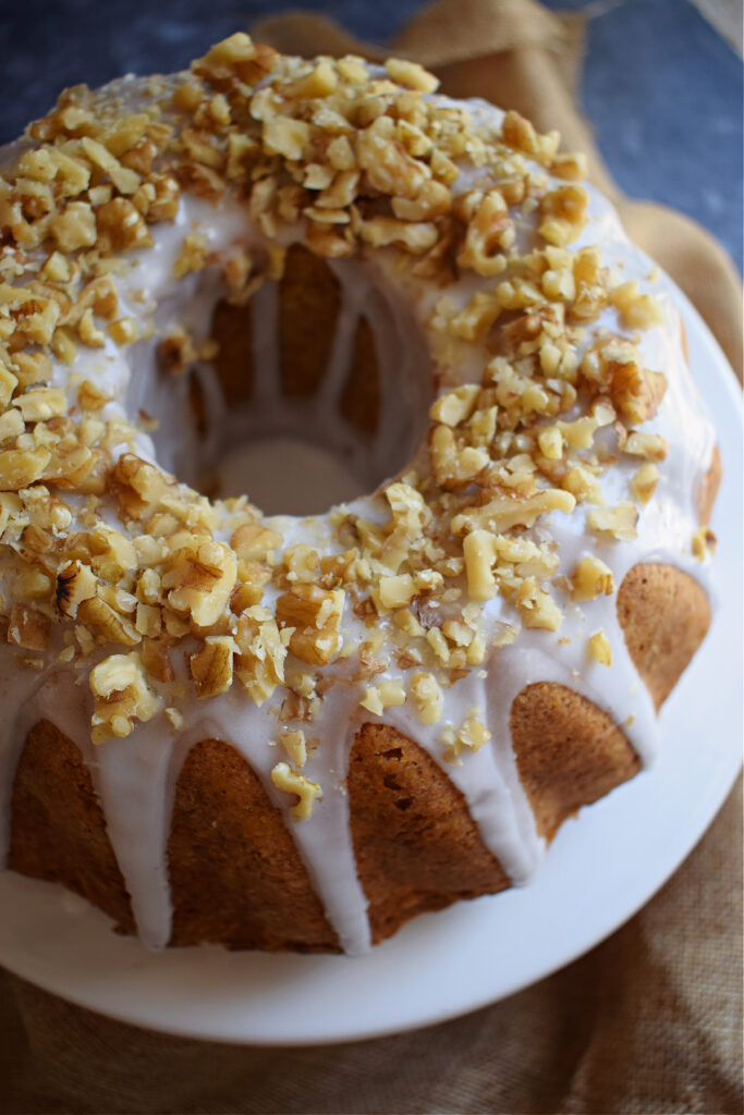 Close up of a glazed carrot bundt cake with nuts.