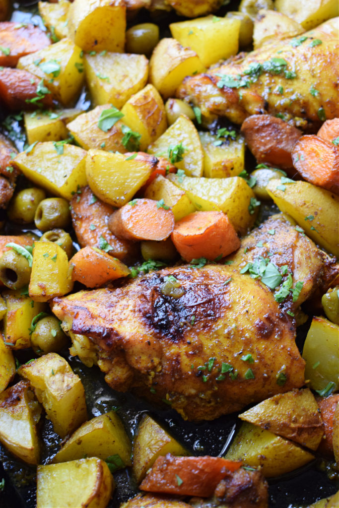 Close up of the Moroccan chicken dinner on a sheet pan.