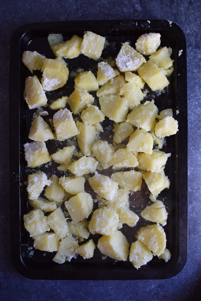 Potatoes on a large baking tray.