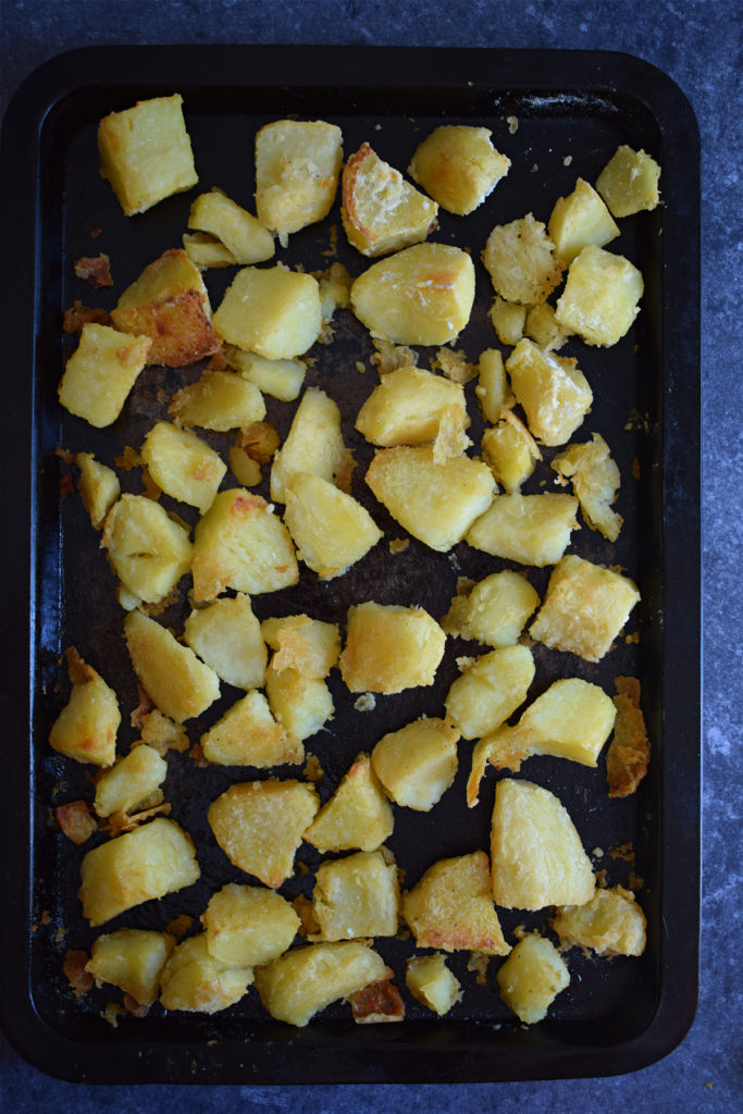 Roasted potatoes on a baking tray.