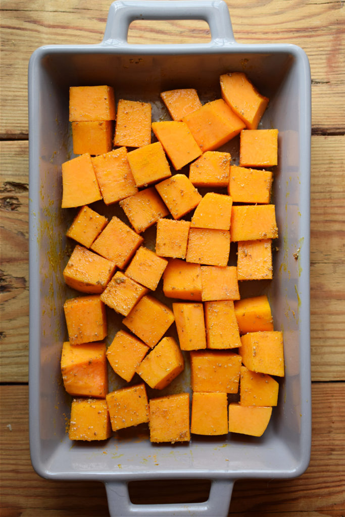 Roasted squash in a roasting dish.