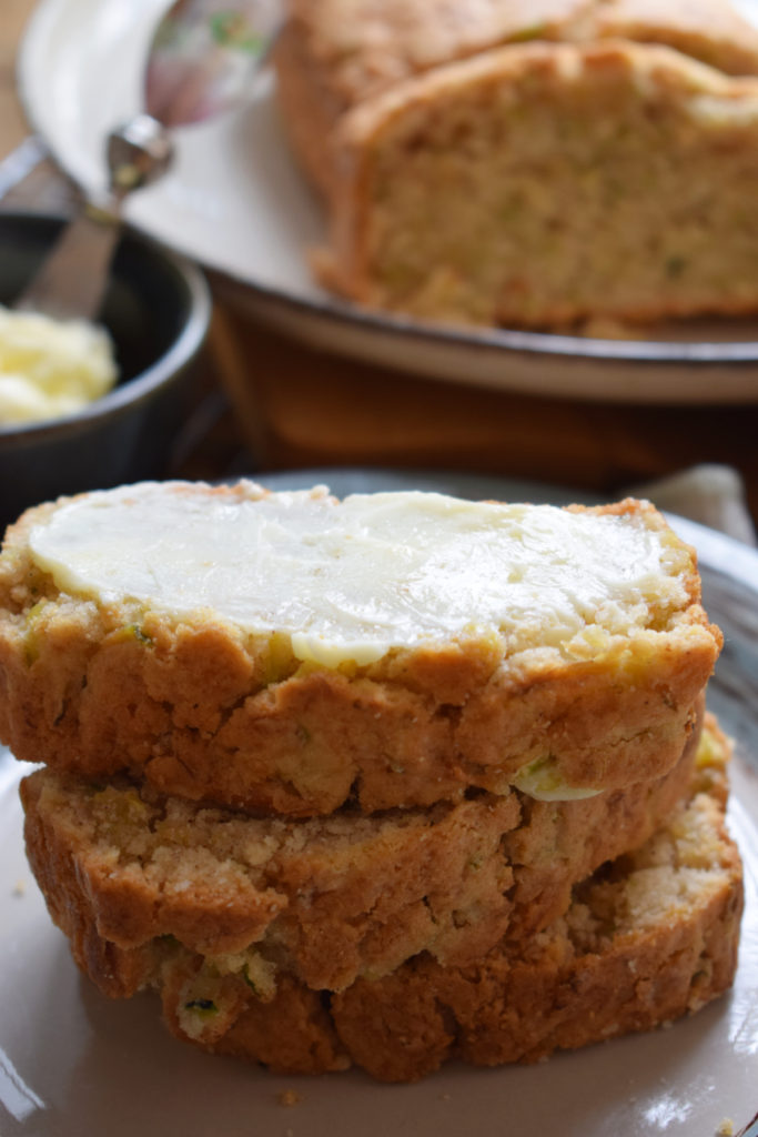Buttered zucchini bread in a stack.