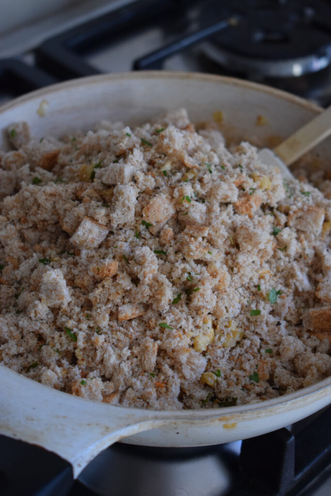 Bread crumb mixture in a white skillet.