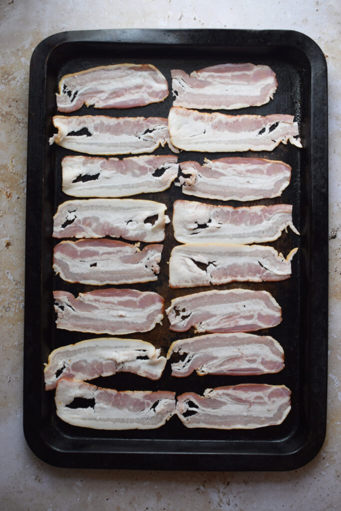 Bacon on a baking tray.