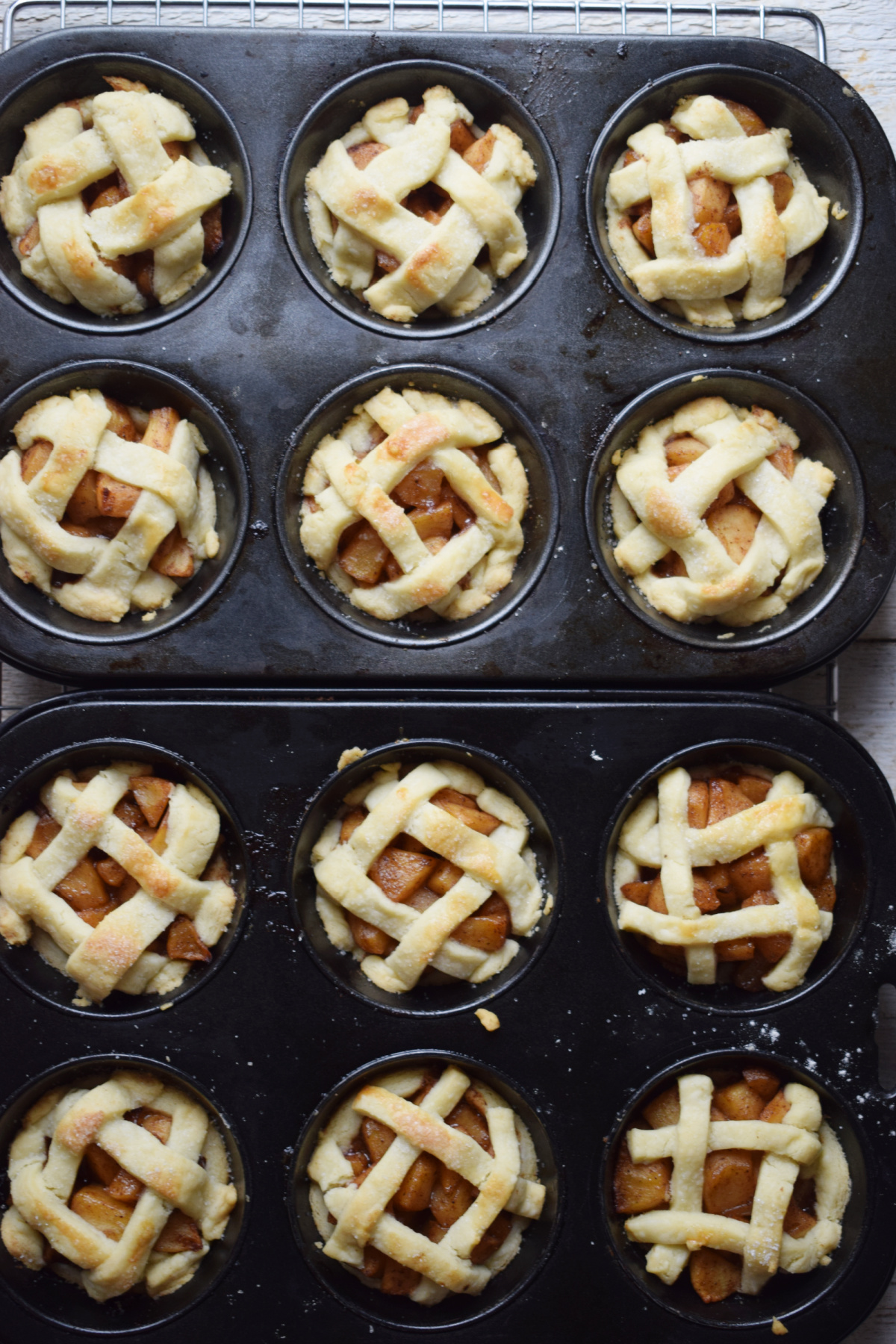 Freshly baked mini apple pies in muffin cups.