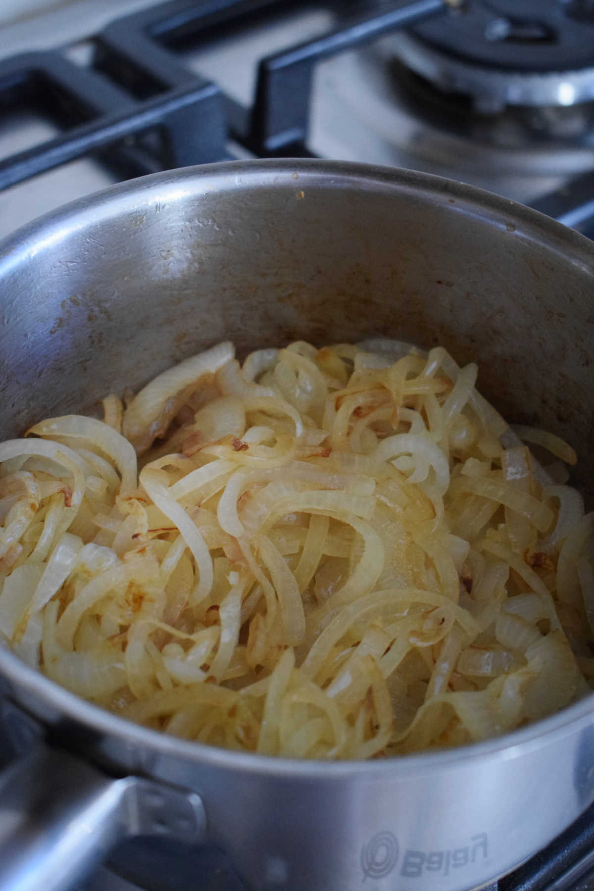 Cooking onions in a saucepan.