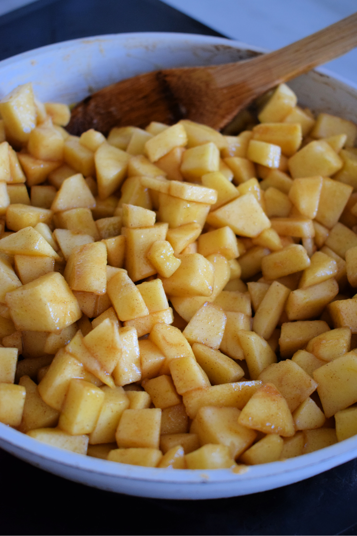 Diced apples in a skillet with brown sugar and butter.