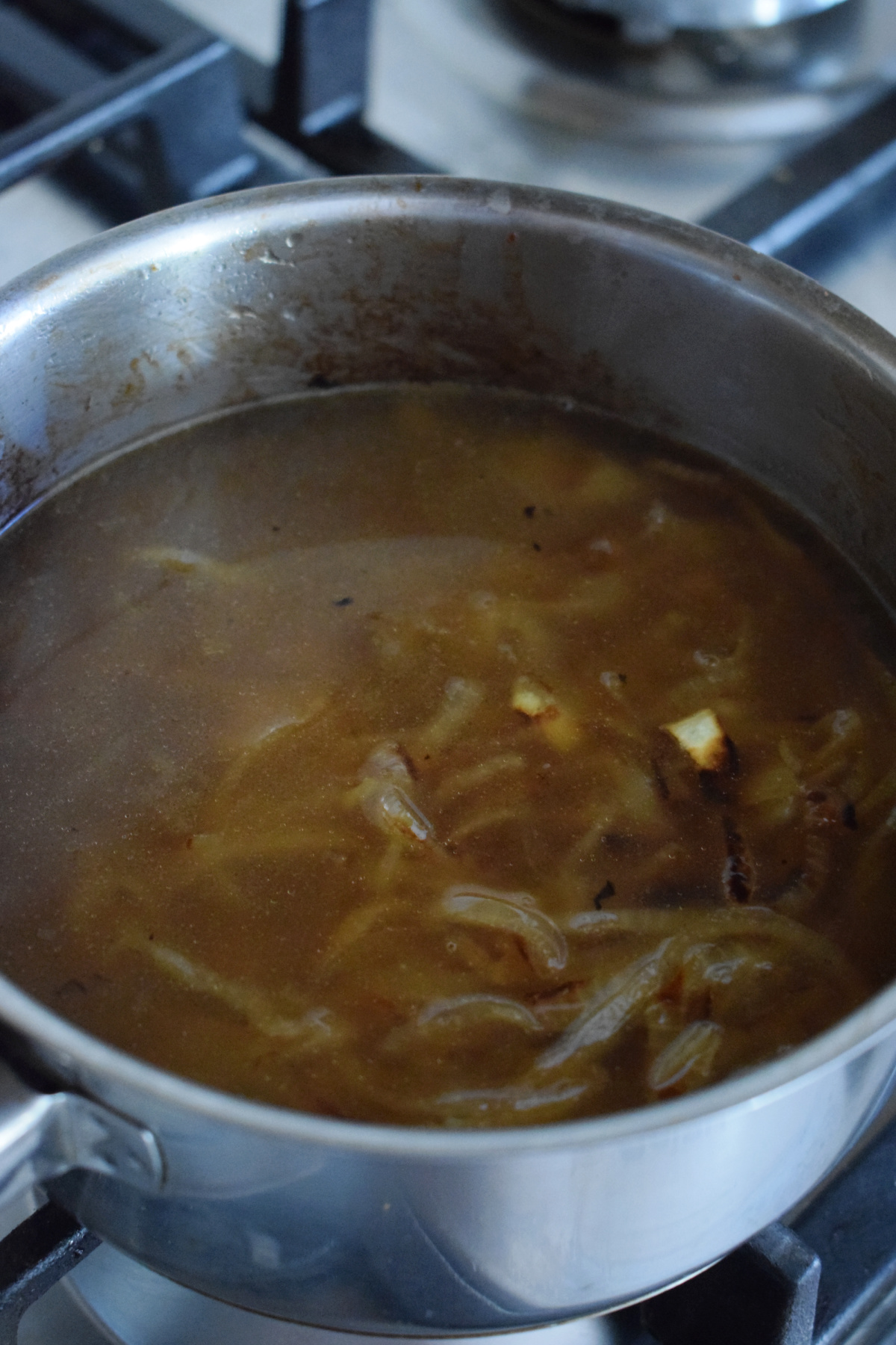 Making onion gravy in a pan.