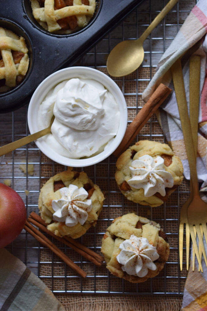 Little apple pies with whipped cream.