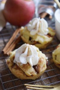 Muffin tin apple pies with cinnamon sticks.