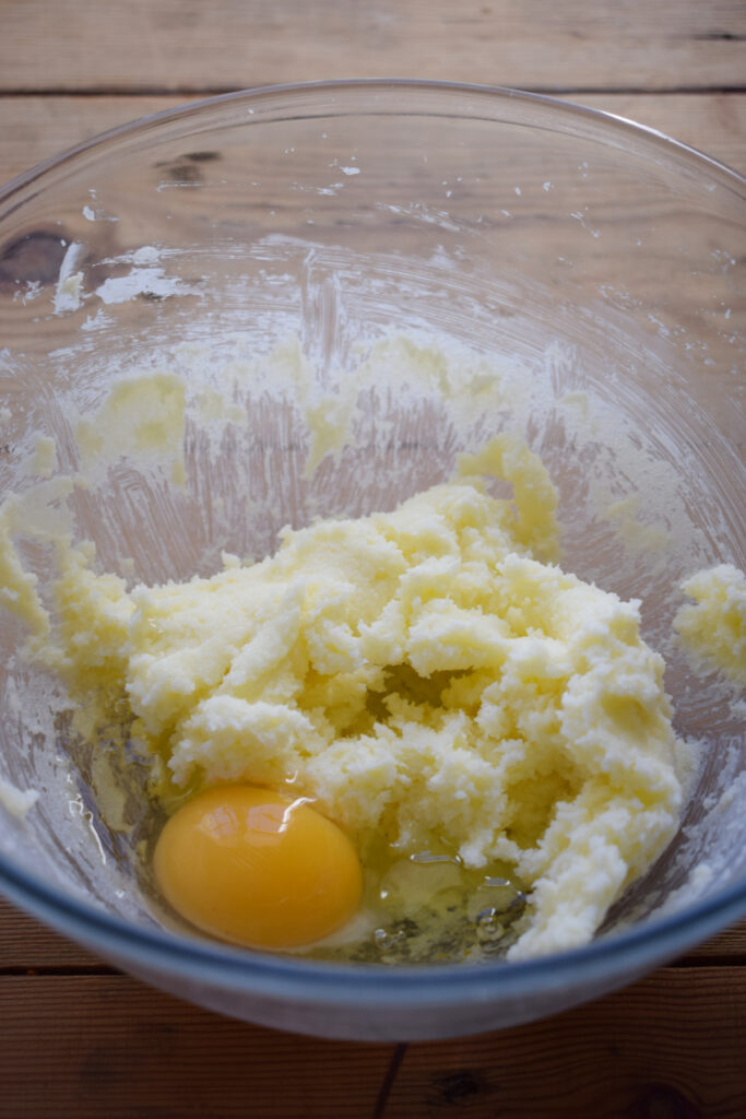 Adding eggs to cake batter.