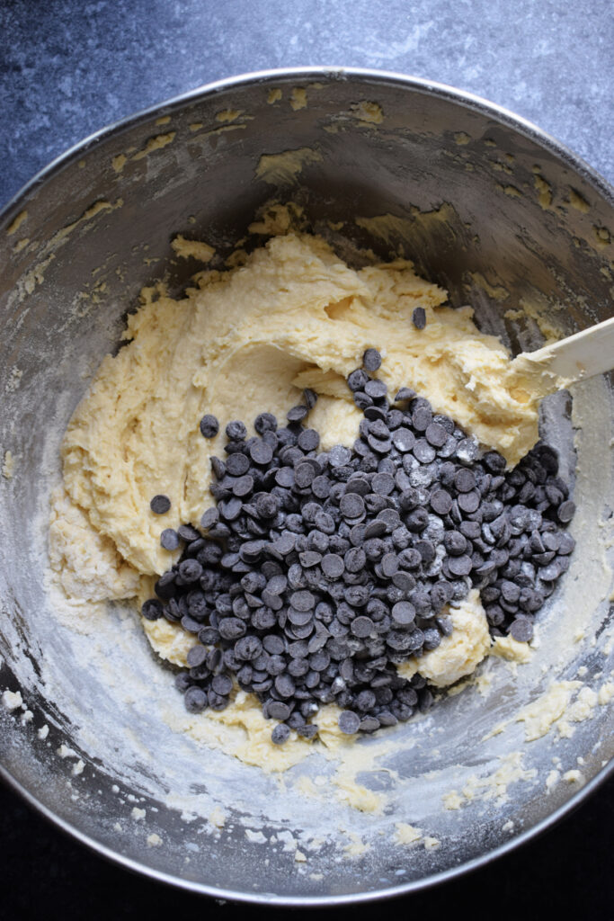 Adding chocolate chips to cake batter.