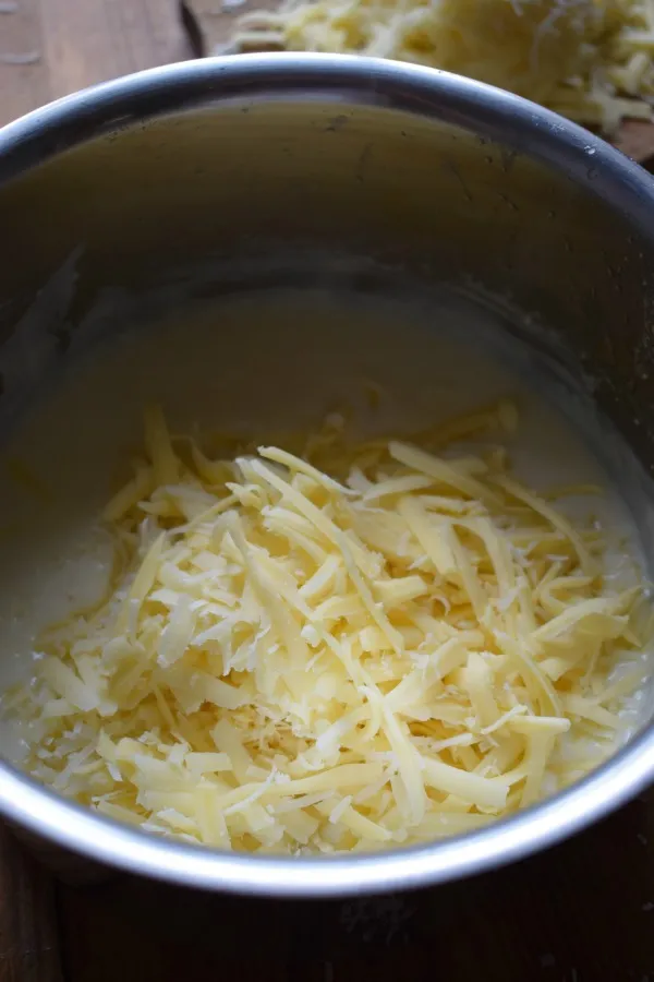 Add cheese to bechamel sauce.