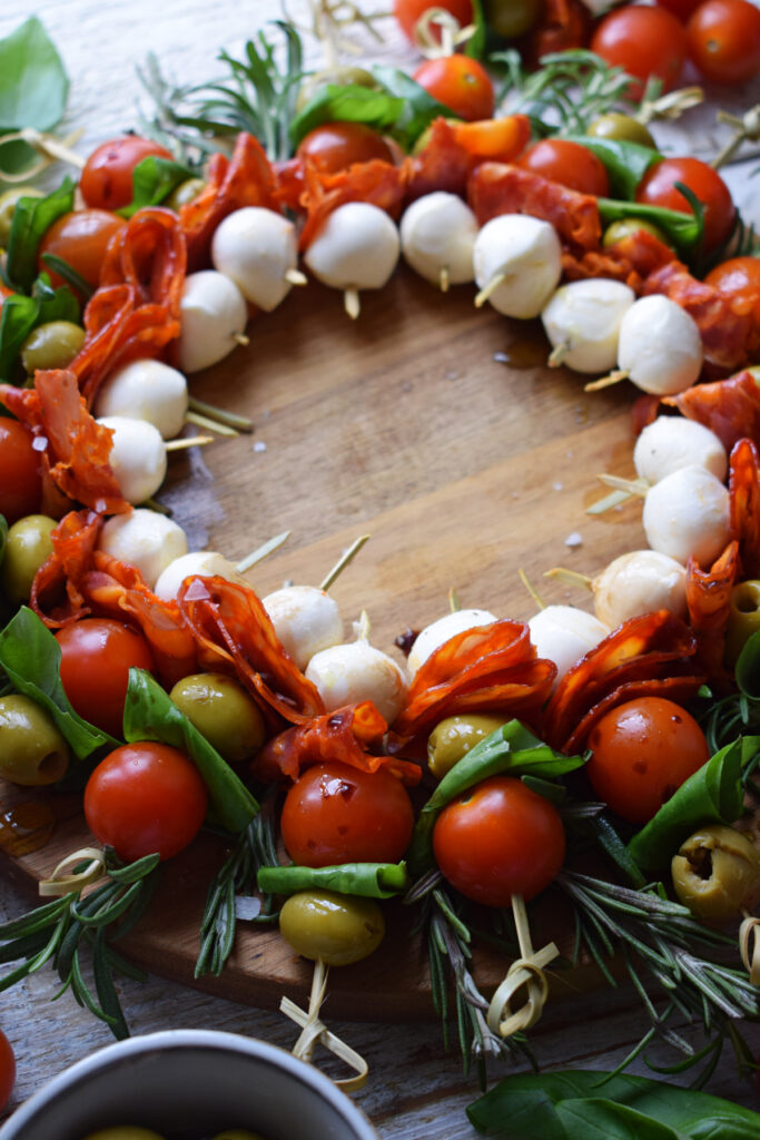 Holiday appetizer wreath on a wooden board.