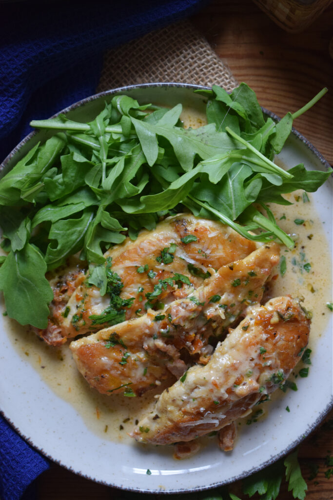 Chicken tenders on a plate with arugula.