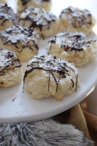 Close up of coconut macaroons on a white plate.