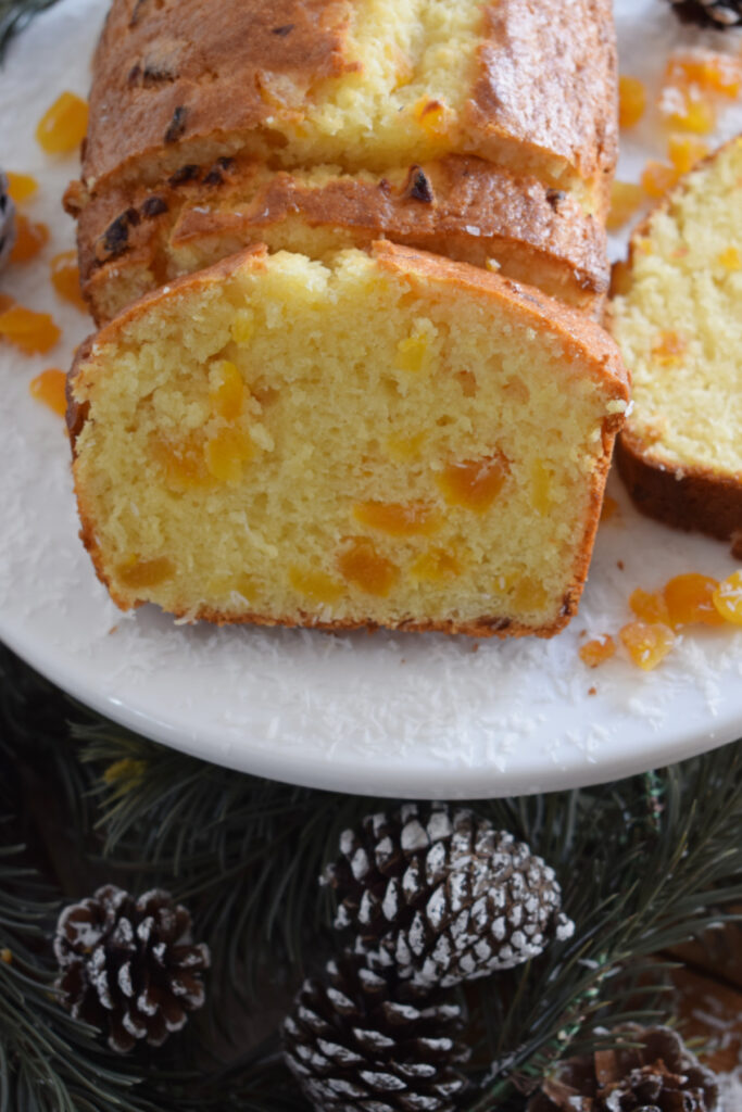 Apricot Christmas cake on a white plate.