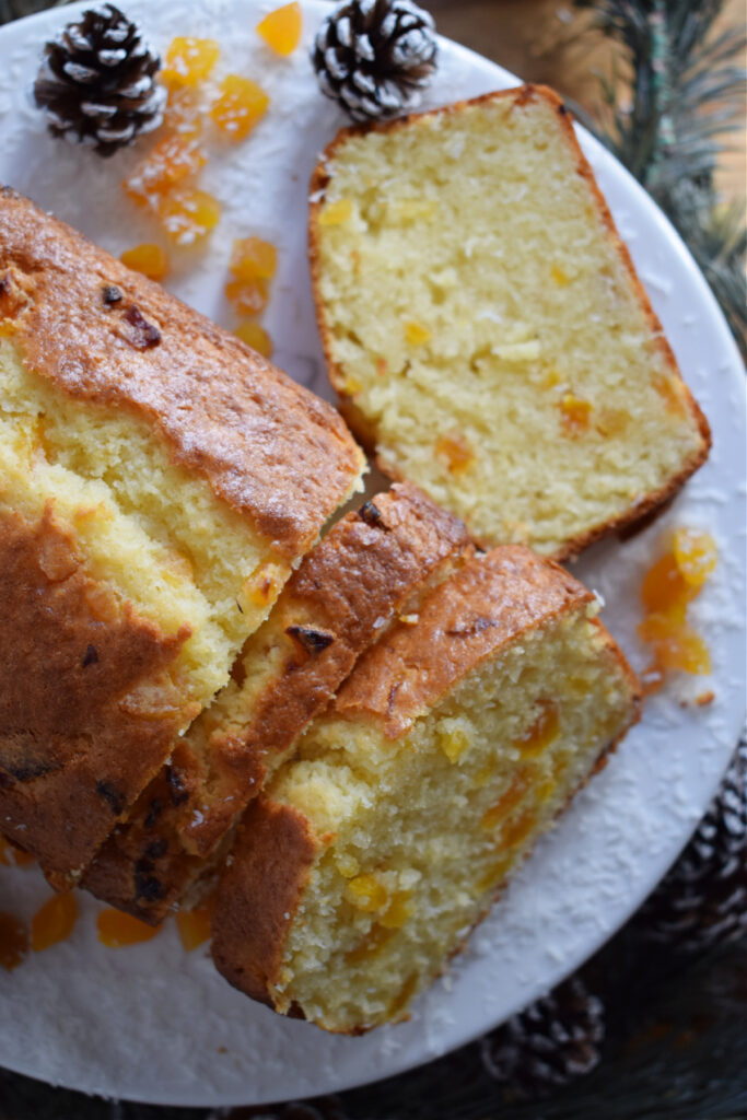 Close up view of Coconut loaf cake on a white plate.