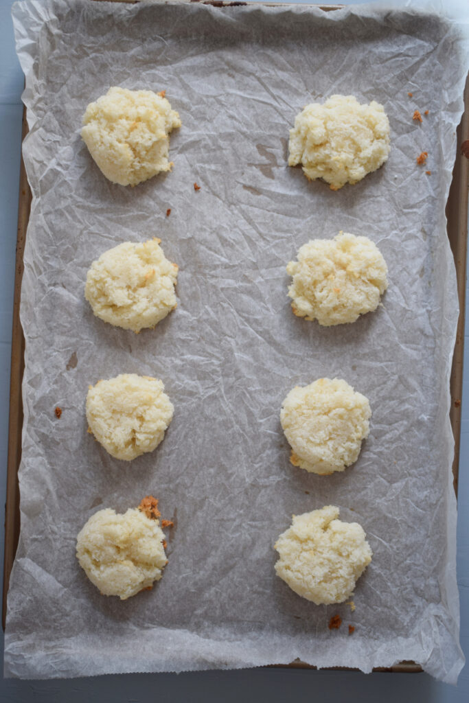 Baked macaroons on a baking tray.