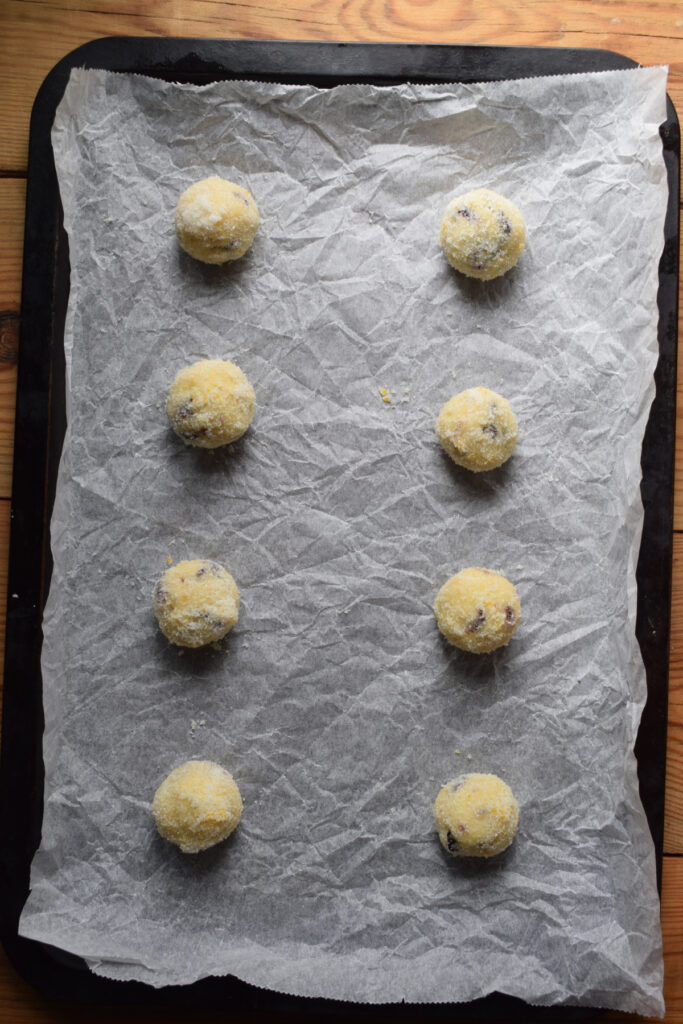 Cookie dough balls on a baking tray.