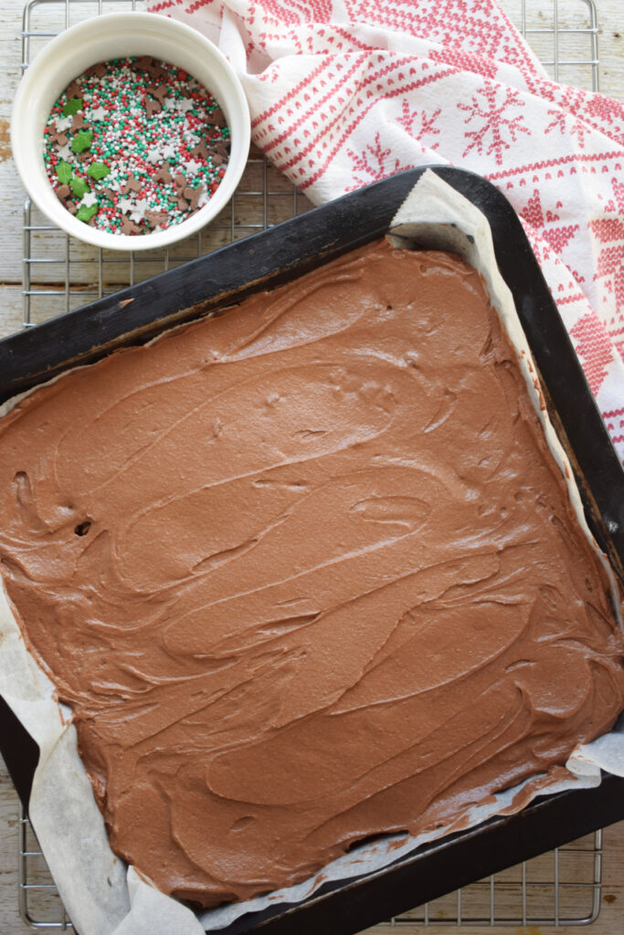 Frosted brownies in a baking tray.