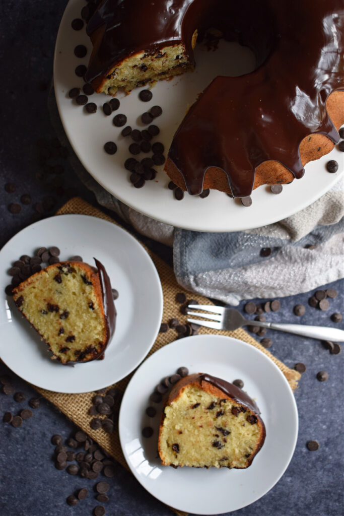 Slices of chocolate chip cake on small white plates.