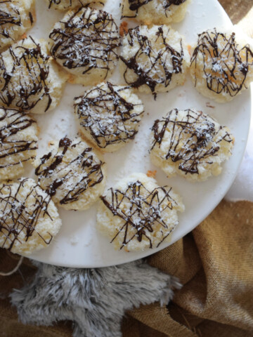 Coconut macaroons on a white serving dish.
