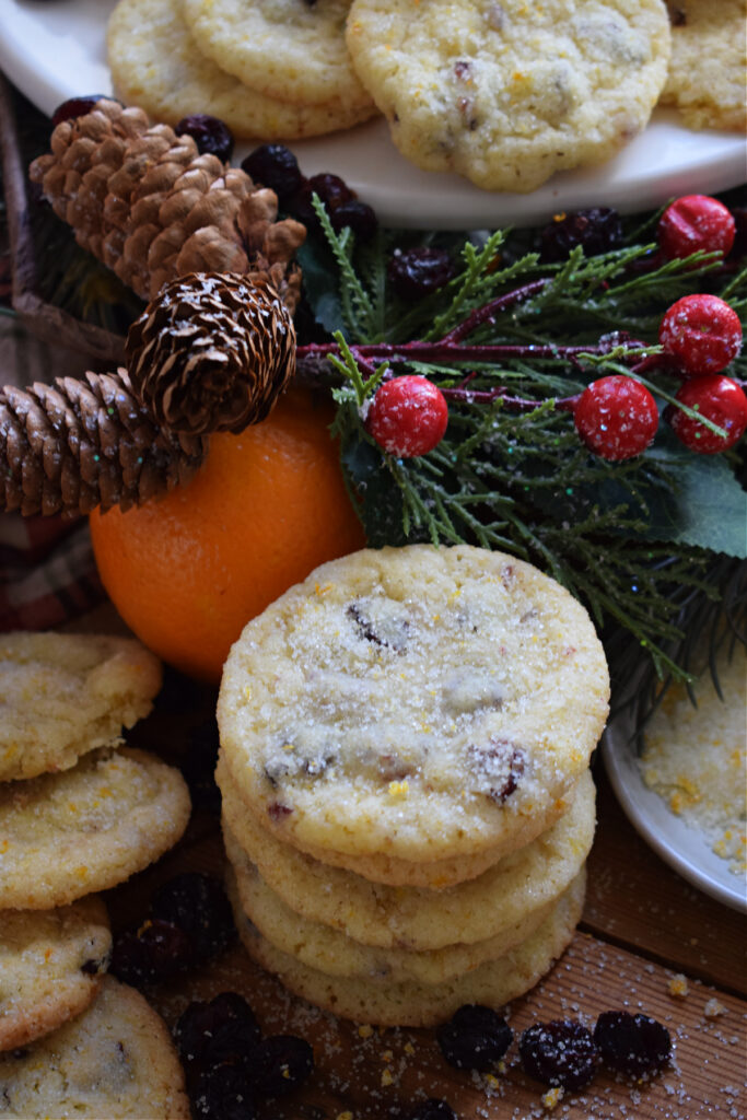 A stack of orange cranberry cookies with Christmas holly.