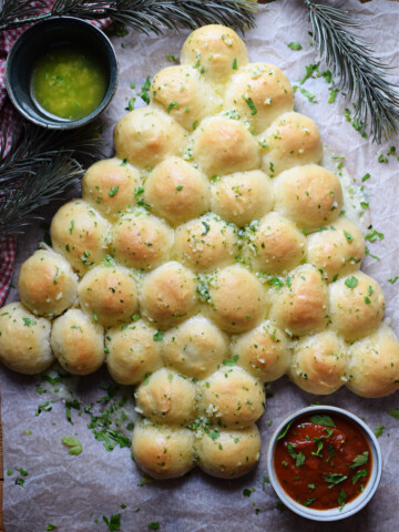 Christmas tree dinner rolls on a tray.