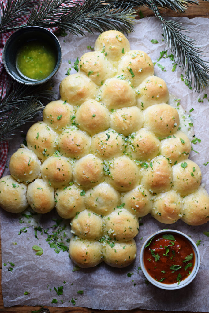 Christmas tree dinner rolls on a tray.