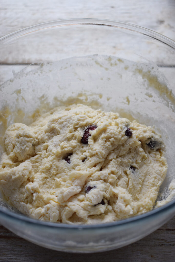 Cranberry scone dough in a glass bowl.