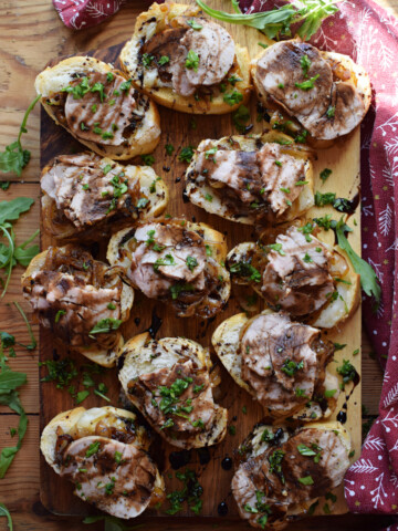 Crostini topped with pork and caramelized onions.
