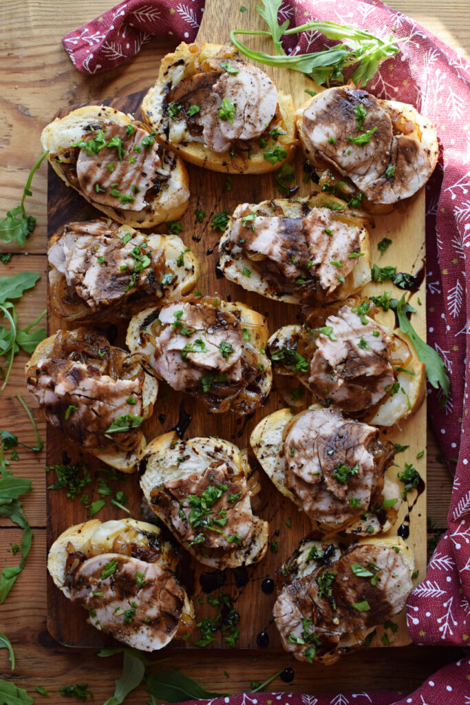 Crostini topped with pork and caramelized onions.