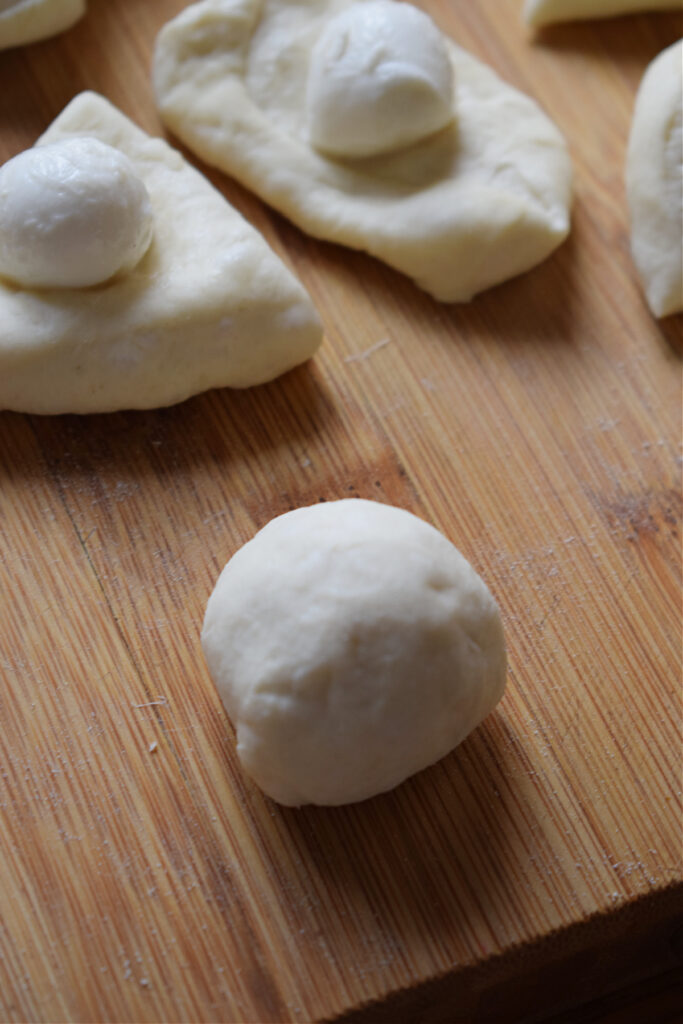 Making cheesy bread rolls.