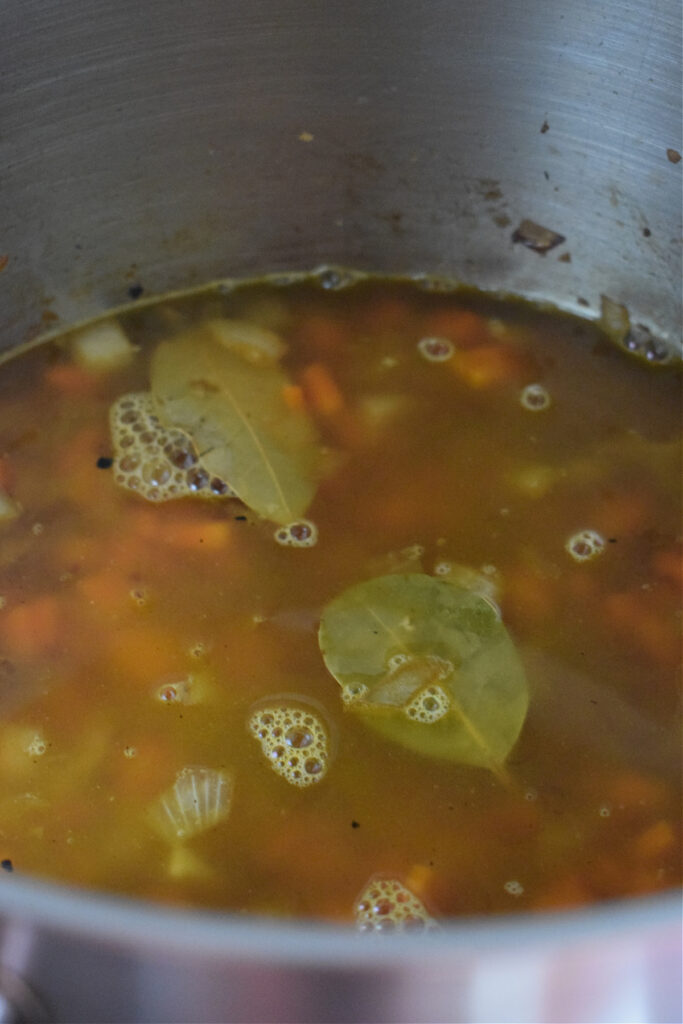 Making soup in a large pot.