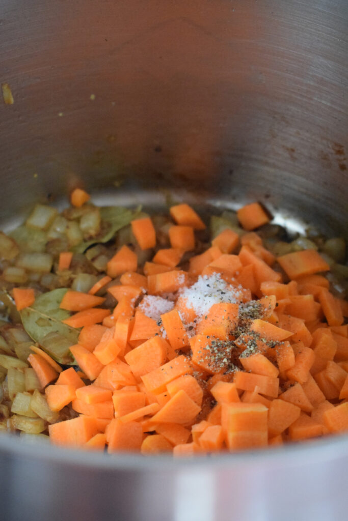 Carrots in a large pot with seasonings.