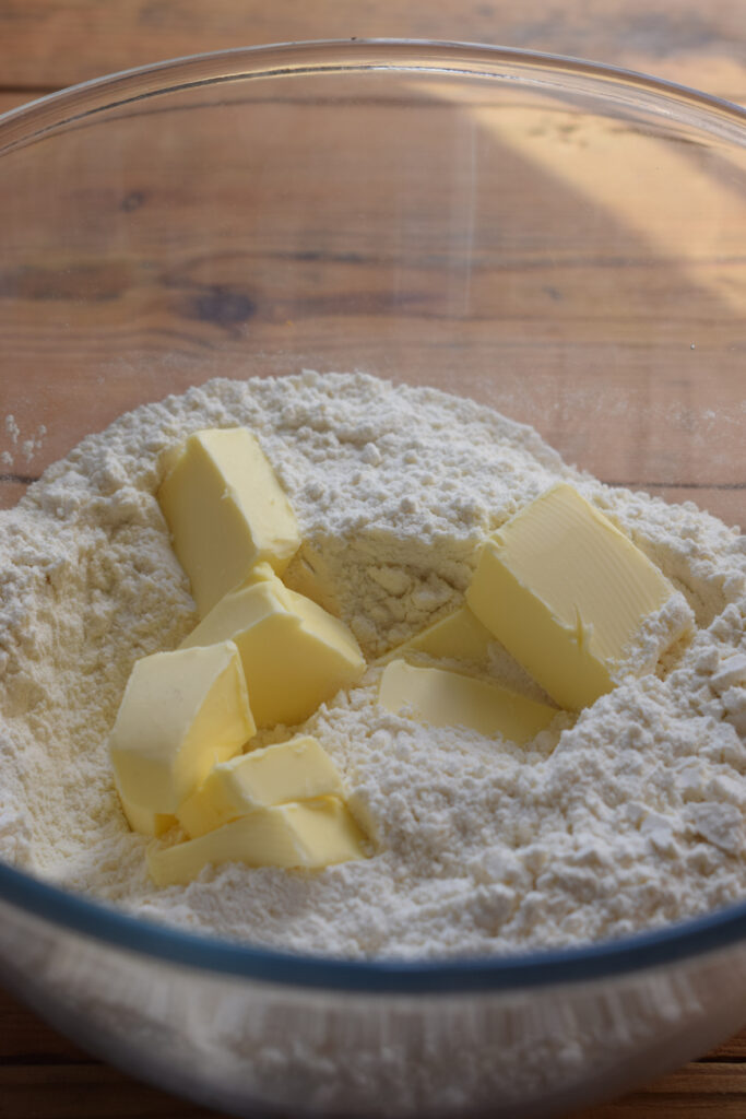 Cold butter and flour in a glass bowl.