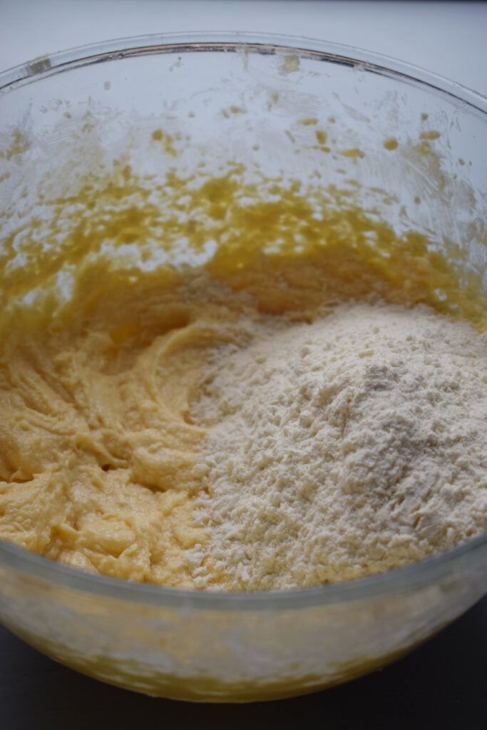 Adding flour to muffin batter.