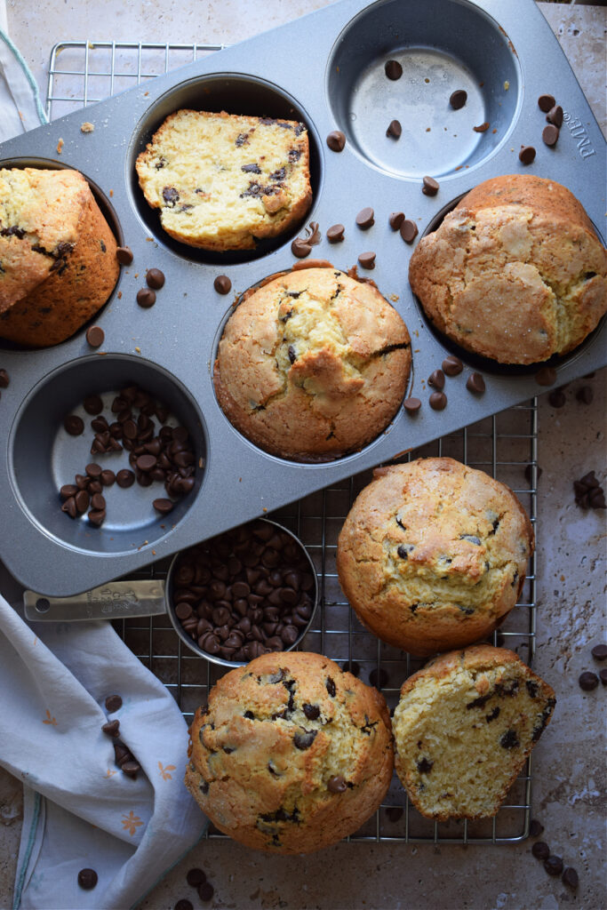 Muffins in a tray with extra chocolate chips.