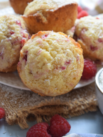 Close up of raspberry muffins with fresh raspberries.