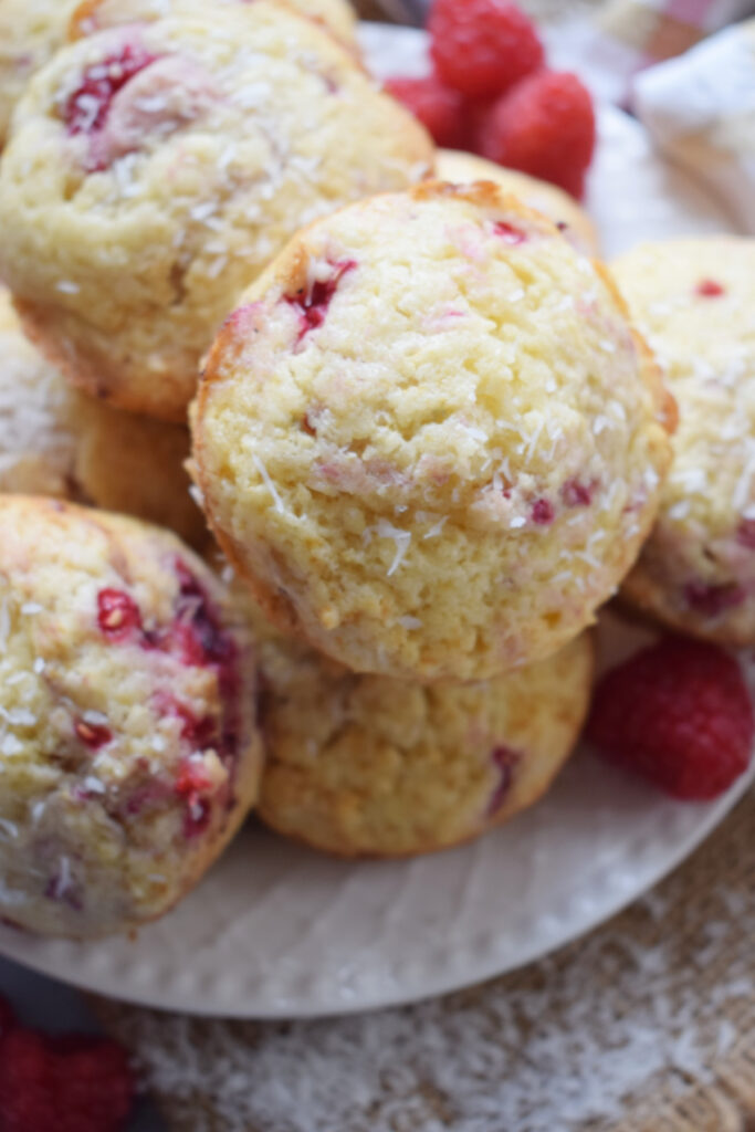 Raspberry muffins with coconut on a plate.