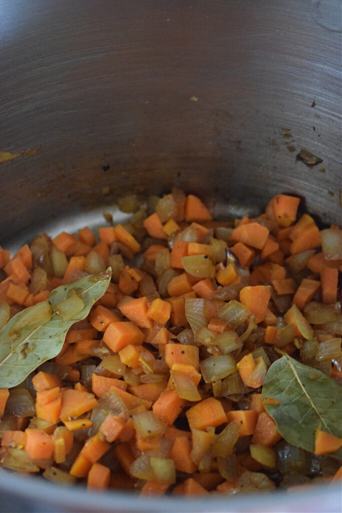 Cooking carrots in a large pot.