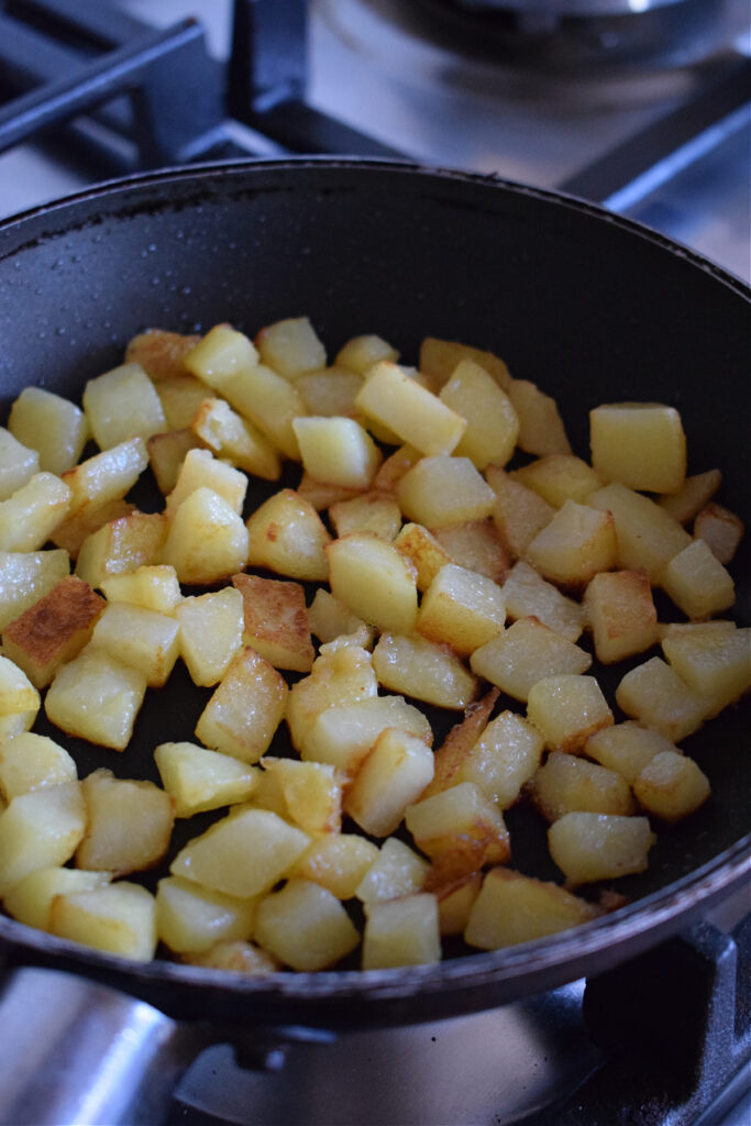 Cooked potatoes in a skillet.