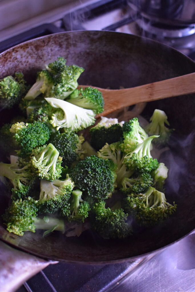 Cooking broccoli in a wok.