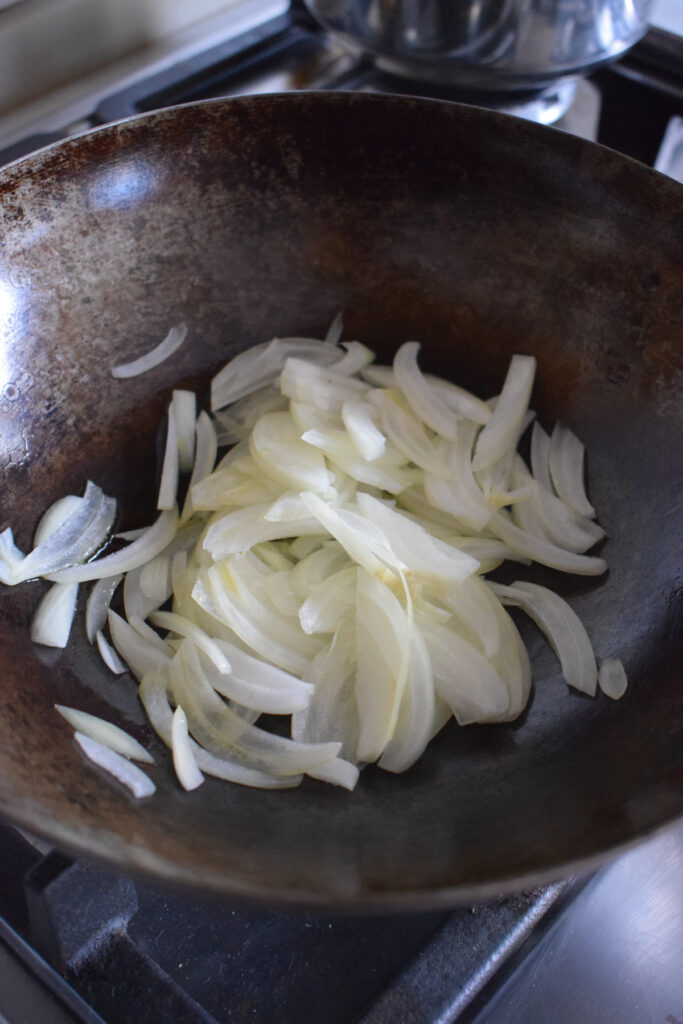 Cooking onions in a wok.
