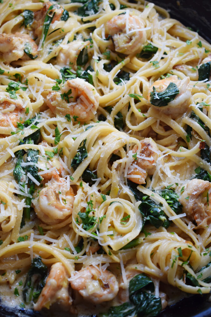 Close up of shrimp and spaghetti with spinach.