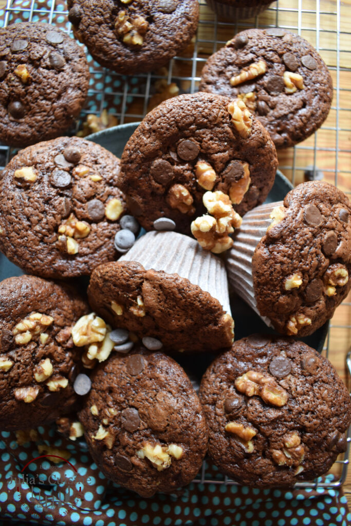Double chocolate walnut muffins on a cooling rack.