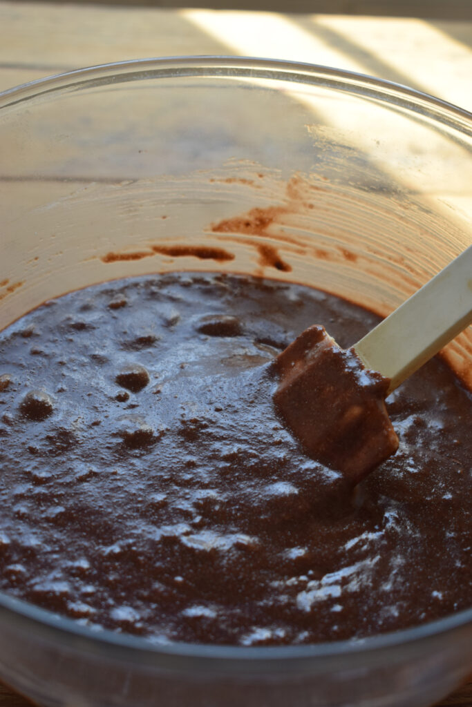 Making chocolate pudding in a glass bowl.